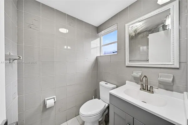 a kitchen with a sink a refrigerator and cabinets