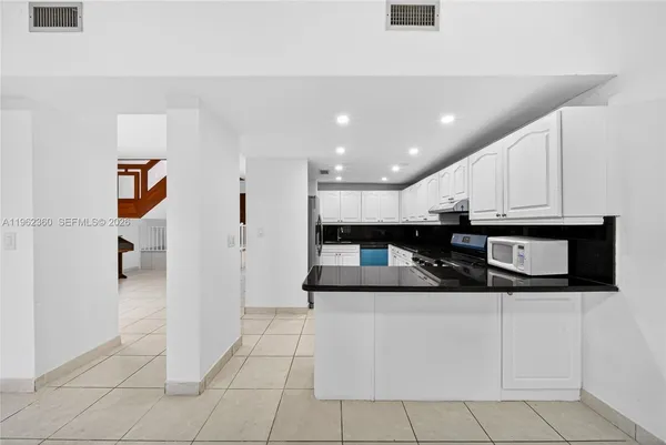 a kitchen with stainless steel appliances a refrigerator sink and cabinets