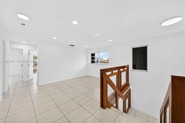 a view of an empty room with kitchen