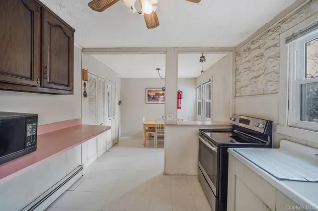 a kitchen that has a lot of cabinets in it and wooden floors