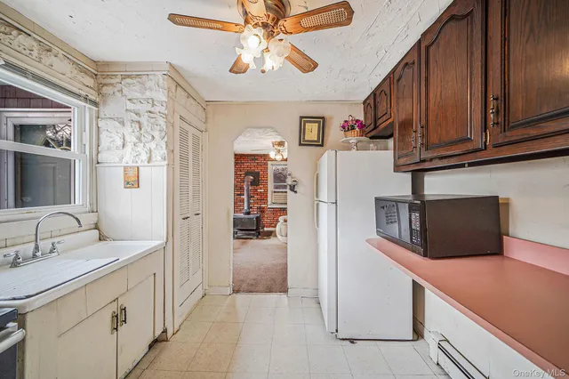 a view of a dining room with furniture and a chandelier