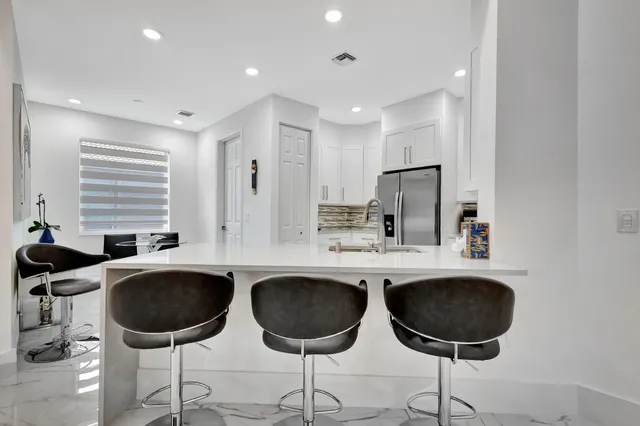a kitchen with cabinets stainless steel appliances and a counter space
