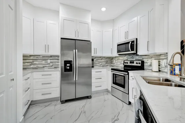 a kitchen with stainless steel appliances wooden cabinets and stove