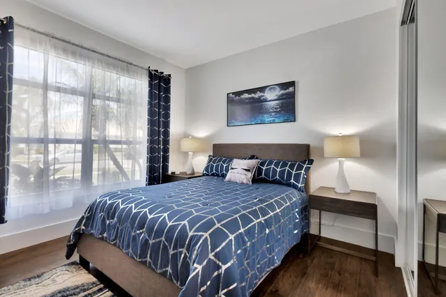 a bedroom with a bed and a lamp