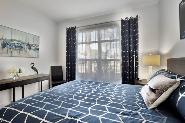 a bedroom with a bed and window