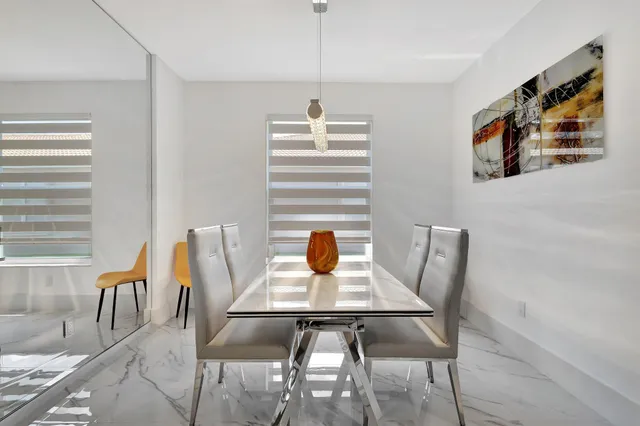 a view of a kitchen area with furniture and wooden floor