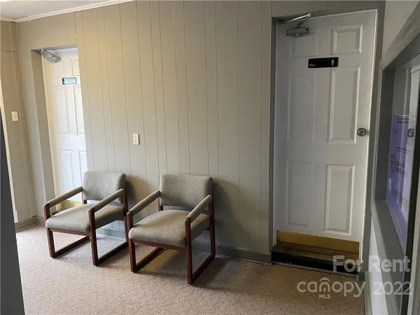 a view of a room with furniture and a window