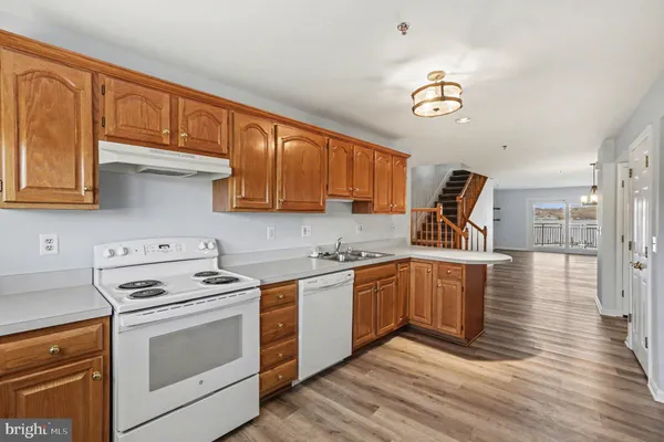 a kitchen with cabinets a sink and appliances