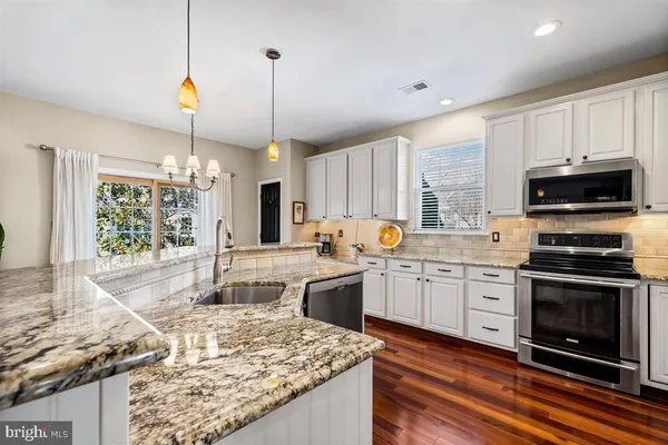 a kitchen with a sink cabinets and utility