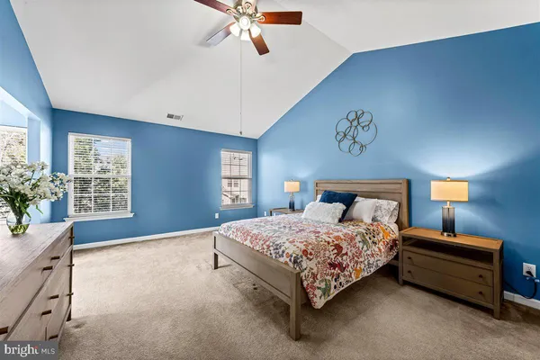 a living room with furniture and a wall painting