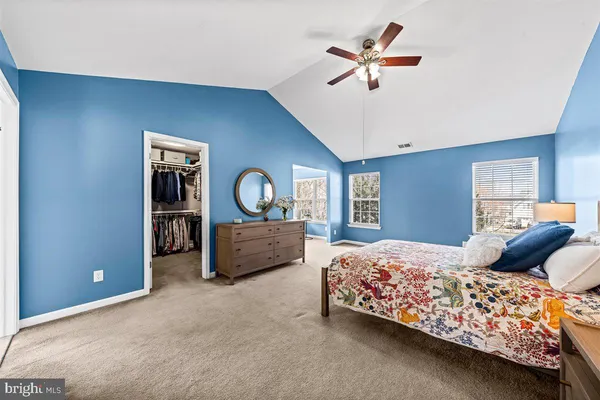 a large spacious bathroom with a tub double sink and mirror