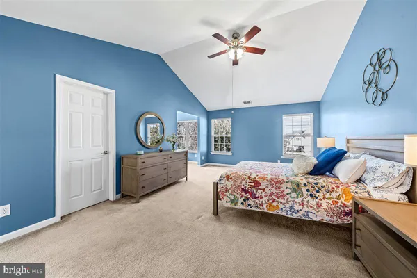 a bed room with a bed and a ceiling fan