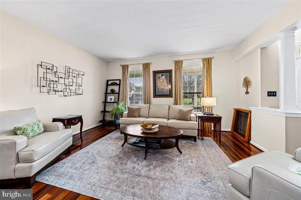 a view of a dining room with furniture a chandelier and wooden floor