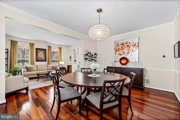 a view of a dining room with furniture wooden floor and chandelier
