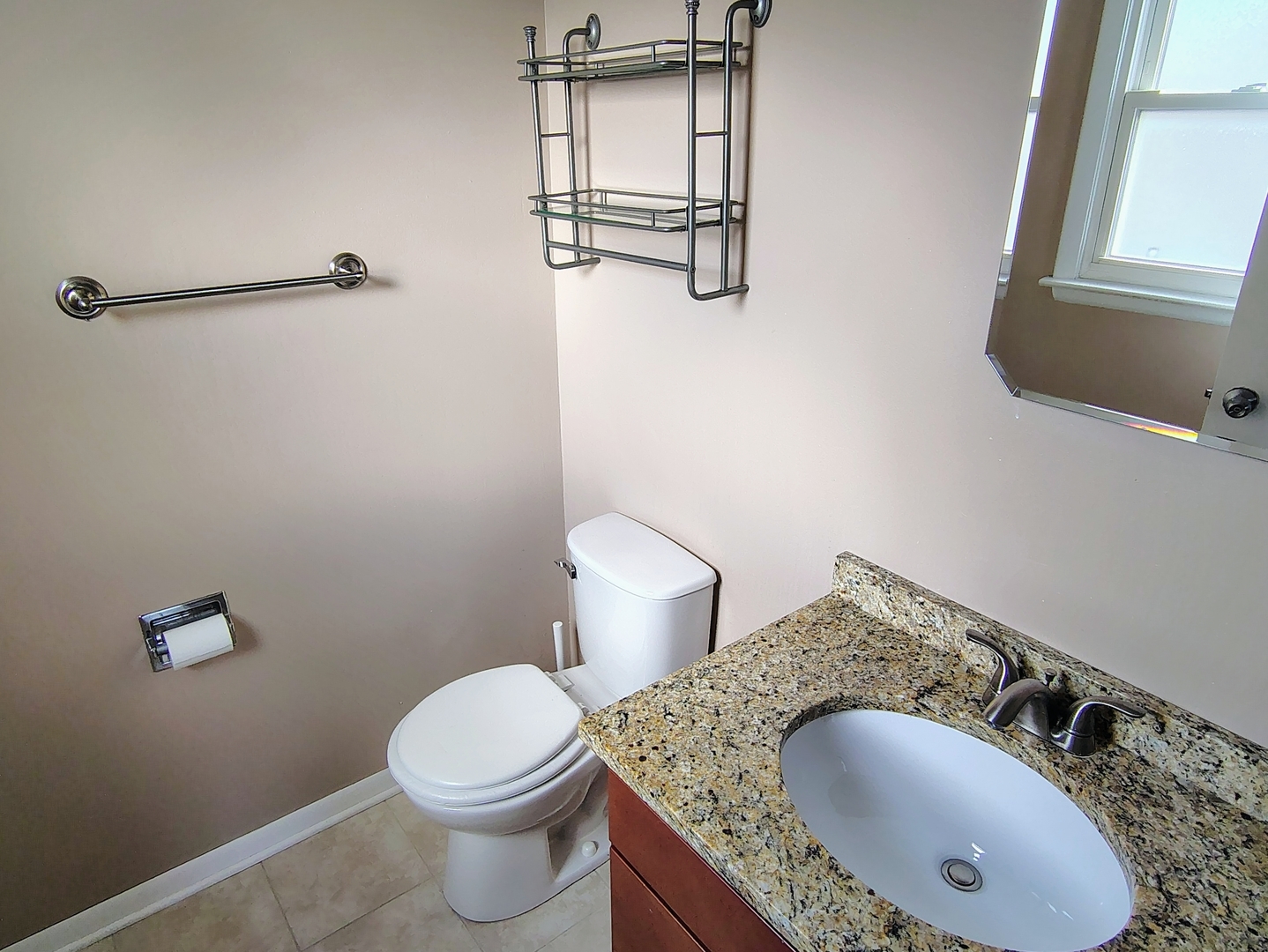 539 Ida Court, Unit 2 Mount Prospect, IL 60056 - Photo 6 of 9 a bathroom with a granite countertop toilet sink and mirror