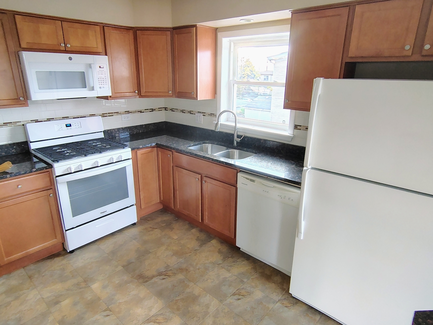 539 Ida Court, Unit 2 Mount Prospect, IL 60056 - Photo 7 of 9 a kitchen with a sink a stove and a refrigerator