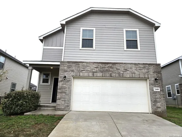 a front view of a house with a garage