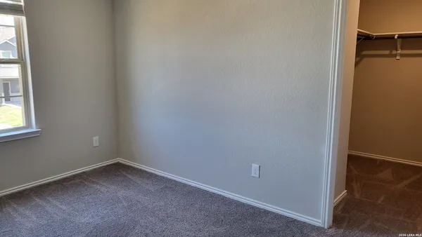 an empty room with closet area