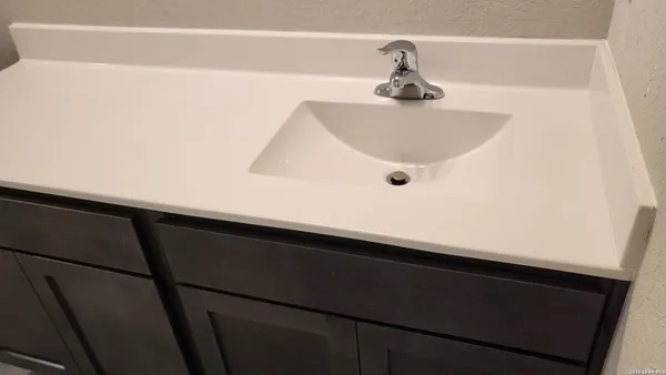 a white toilet sitting next to a shower