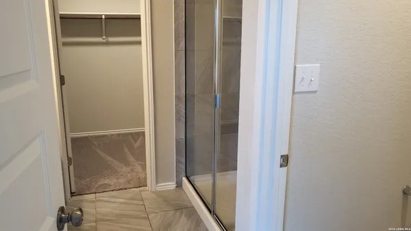 an empty room with windows and closet