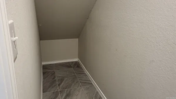 a view of a livingroom with an empty space and a window