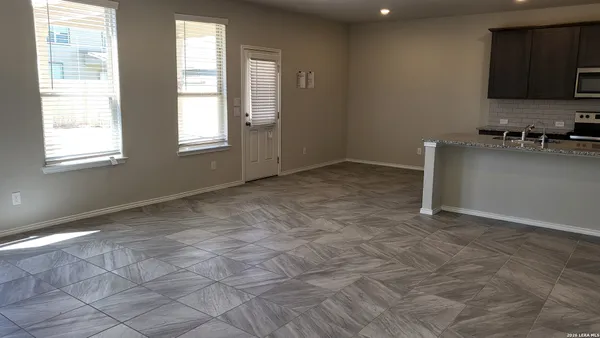 a kitchen with stainless steel appliances granite countertop a sink stove and microwave