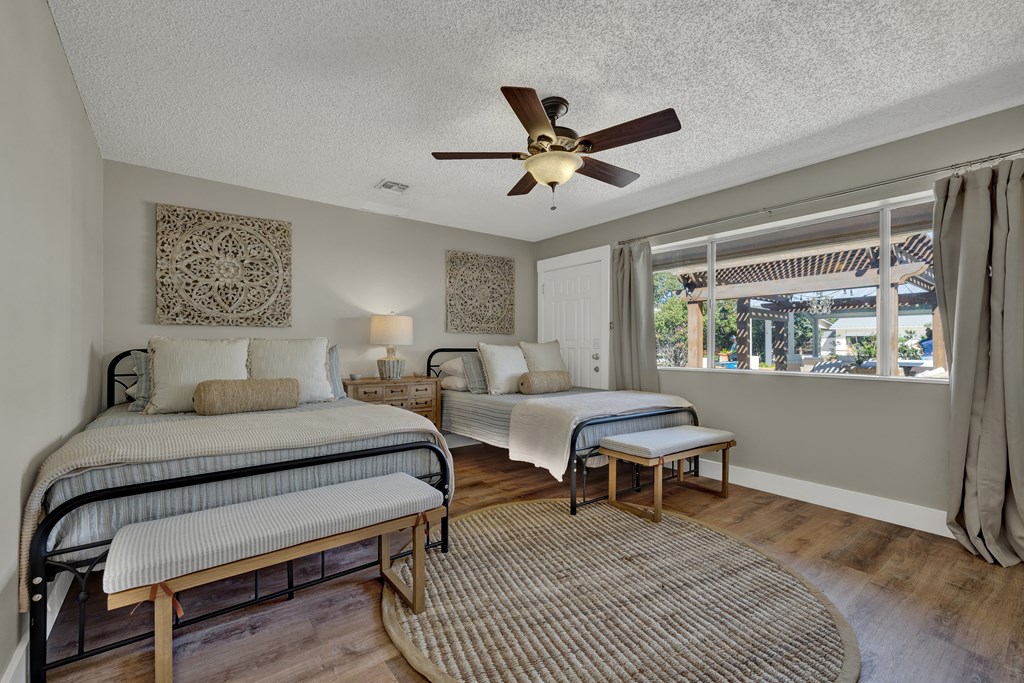 113 Weitz Road Fredericksburg, TX 78624 - Photo 11 of 50 a bedroom with a bed window and a table