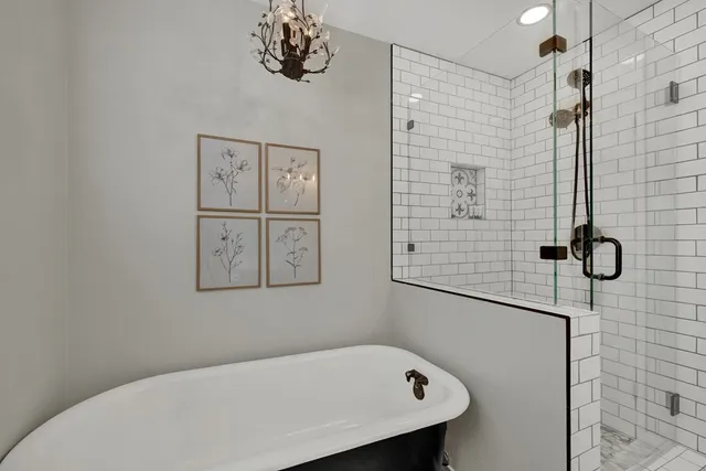 a bathroom with a bathtub and shower