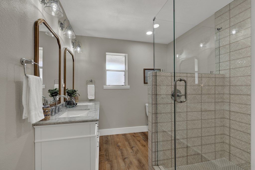 113 Weitz Road Fredericksburg, TX 78624 - Photo 14 of 50 a bathroom with a double vanity sink a mirror and shower