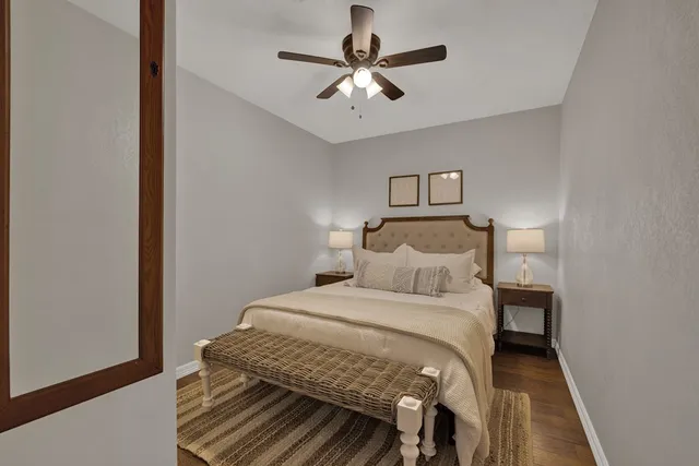 a bedroom with a bed and a ceiling fan