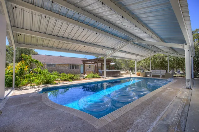 a view of a swimming pool with a patio