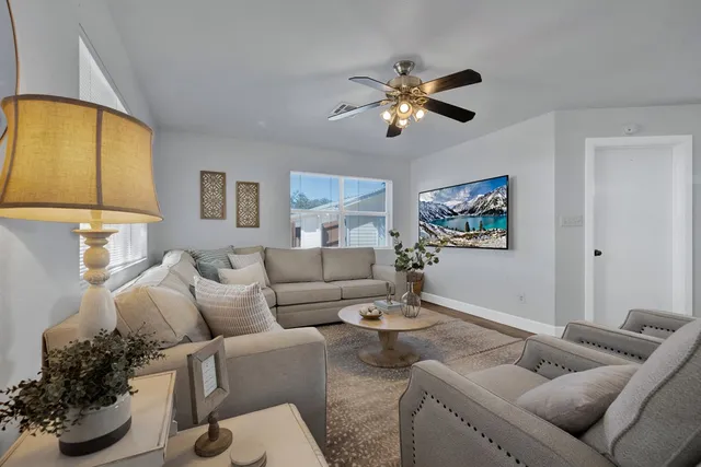 a living room with furniture and a potted plant