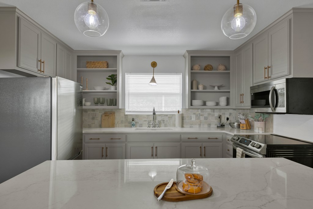 113 Weitz Road Fredericksburg, TX 78624 - Photo 40 of 50 a kitchen with stainless steel appliances granite countertop a sink and cabinets