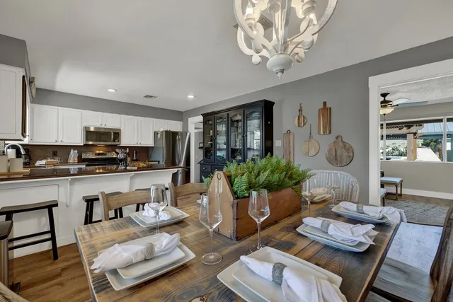 a living room with furniture kitchen view and a dining table