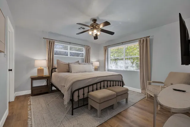 a bedroom with a bed couch and window