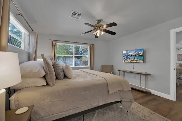 a bedroom with a large bed and a window