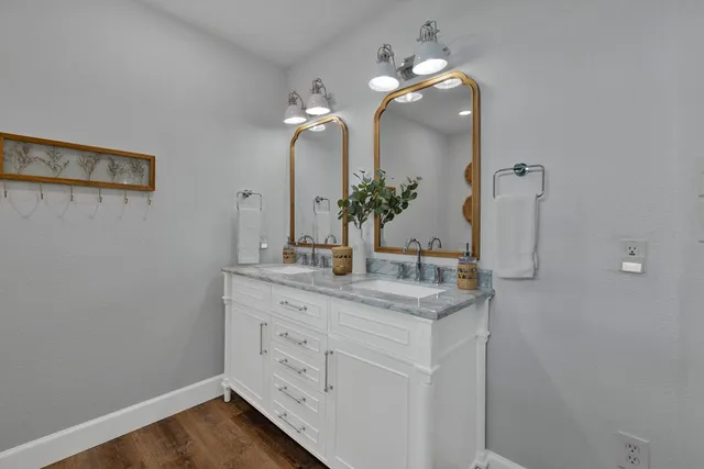 a bathroom with a double vanity sink and a mirror