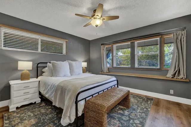 a bedroom with bed and a large window