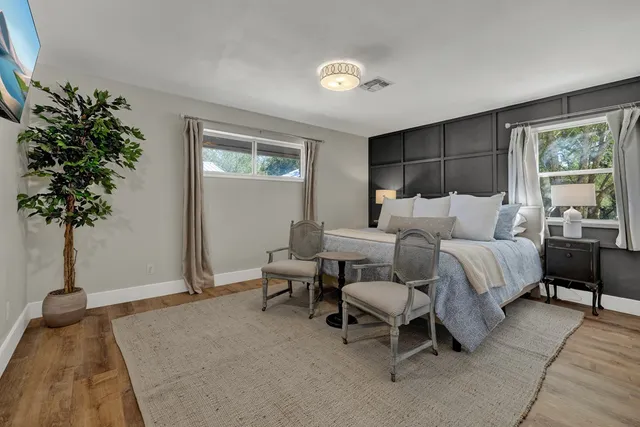 a bedroom with a bed and a potted plant