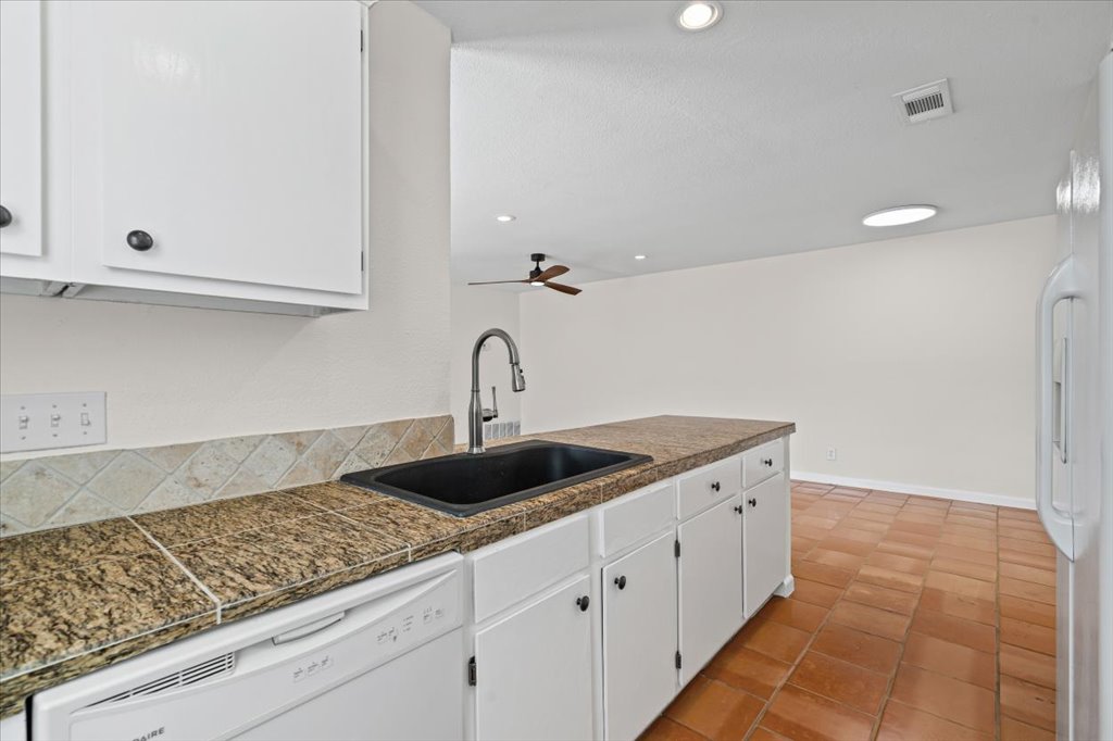 303 Fantail Loop, Unit A Austin, TX 78734 - Photo 15 of 28 a kitchen with a sink and cabinets