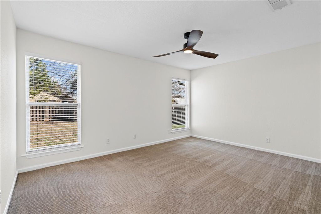 303 Fantail Loop, Unit A Austin, TX 78734 - Photo 19 of 28 a view of an empty room with a window