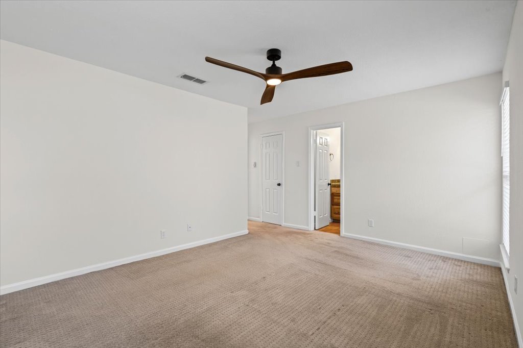 303 Fantail Loop, Unit A Austin, TX 78734 - Photo 20 of 28 a view of a room with a ceiling fan and wooden floor