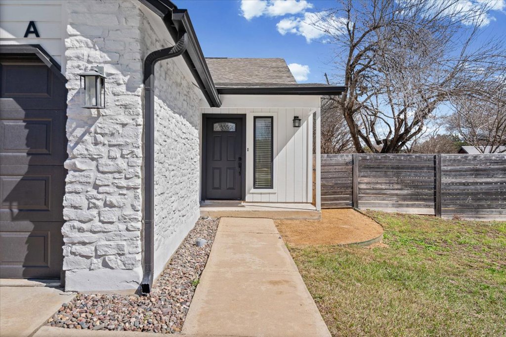 303 Fantail Loop, Unit A Austin, TX 78734 - Photo 3 of 28 a view of a backyard with wooden fence