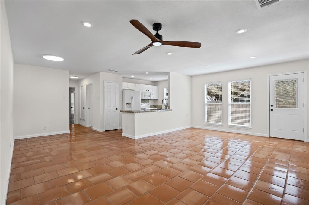 303 Fantail Loop, Unit A Austin, TX 78734 - Photo 5 of 28 a view of empty room with wooden floor and window