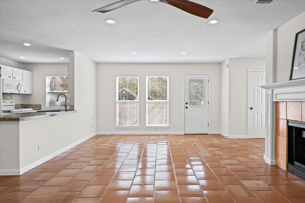 303 Fantail Loop, Unit A Austin, TX 78734 - Photo 6 of 28 a view of empty room with a fireplace