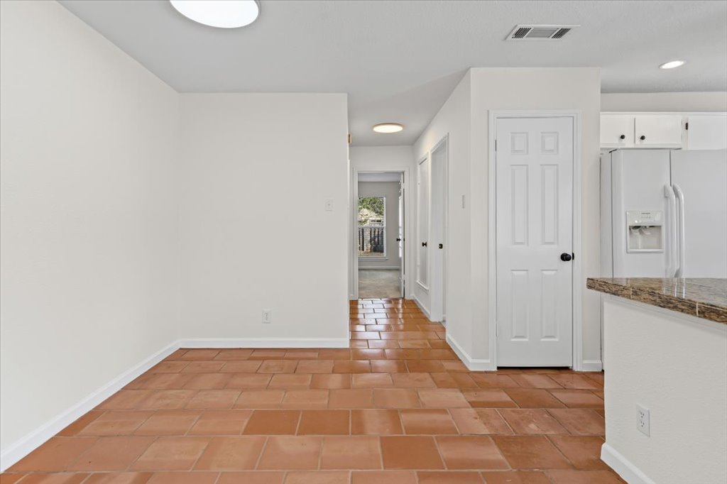 303 Fantail Loop, Unit A Austin, TX 78734 - Photo 10 of 28 a view of a kitchen with a sink and refrigerator