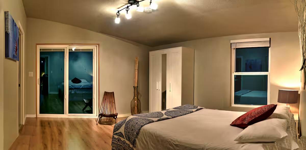8807 High Valley Road Austin, TX 78737 - Photo 18 of 22 Hardwood flooring and vaulted ceilings create an open, comfortable sleeping area with access to the outdoors.