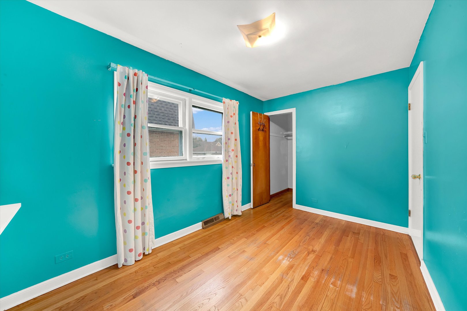 3933 West 58th Street Chicago, IL 60629 - Photo 13 of 32 a view of empty room with closet and wooden floor