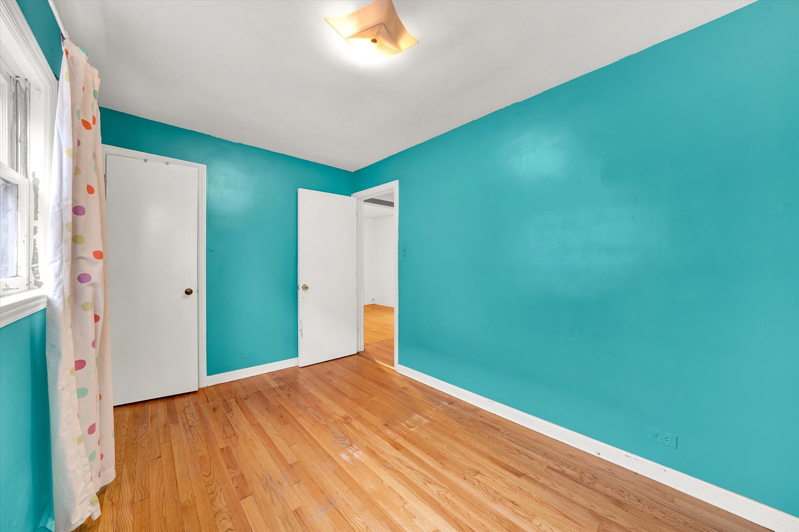 3933 West 58th Street Chicago, IL 60629 - Photo 14 of 32 a view of a big room with closet and wooden floor
