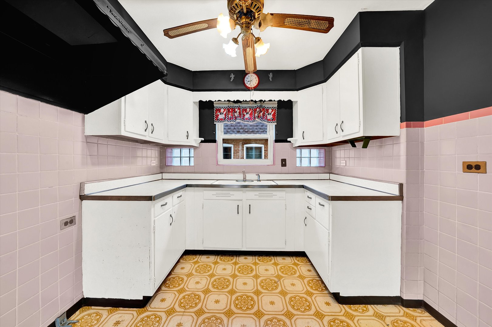 3933 West 58th Street Chicago, IL 60629 - Photo 17 of 32 a kitchen with granite countertop a sink stainless steel appliances and cabinets